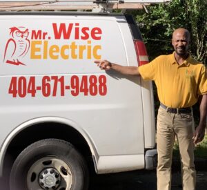 A man standing next to an electric van.