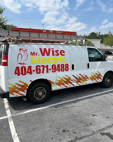 A van with the words " mr. Wise electric 4 0 4-6 7 1-9 4 8 8 ".